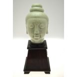 A celadon head of Bodhisattva, 24 cm, on hardwood 'Pyramid' base,