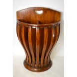 An unusual walnut stick stand of demi-lune form with shaped slat body to a zinc drip tray,