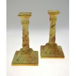 A pair of Victorian Royal Worcester blush ground square based candlesticks painted with flowers,