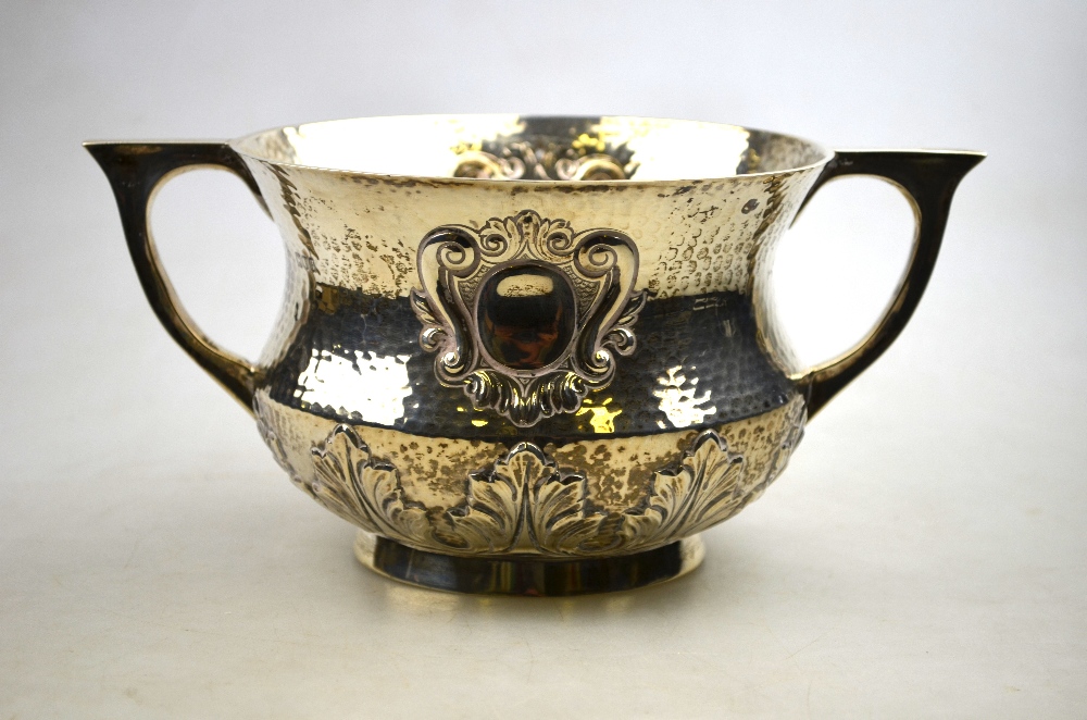 An Edwardian planished silver two-handled porringer or wassailing cup of baluster form with embossed