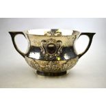 An Edwardian planished silver two-handled porringer or wassailing cup of baluster form with embossed