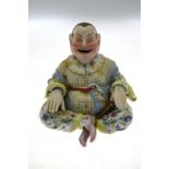 A Meissen 'nodding Chinaman' with hinged head and hands, open grinning mouth, sitting cross-legged