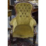 A late Victorian mahogany framed button upholstered scroll armchair