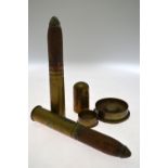 Two WW1 2 pdr artillery shells, 1916, to/w two brass shell-case ashtrays and a brass desk bell,