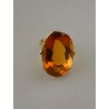 A large cocktail ring set with oval multi-faceted citrine above and below girdle,