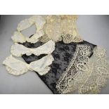 A collection of 19th century and other lace to include a floral bodice panel with pair of matching