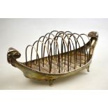 A George III toast rack with eight wire divisions on oval base with gadrooned rims, goat-mask end