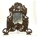 A cast iron strut mirror decorated with elegant 18th century figures,