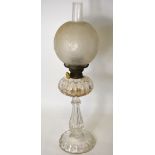 A Victorian cut glass oil lamp with decorative etched glass globe shade