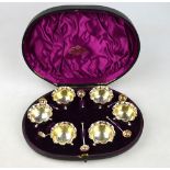 A Victorian cased set of six silver open salts with gilt bowls, on ball feet,