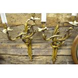 A pair of gilt brass twin-branch wall lights in the rococo manner