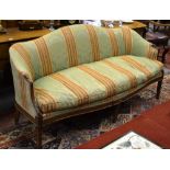 An early 20th century carved walnut framed upholstered arched back sofa,