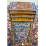 A set of antique quarter veneered walnut quartetto tables raised in simulated bamboo style supports