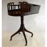 A George III mahogany wine/cutlery stand with galleried revolving D-end raised on a turned support
