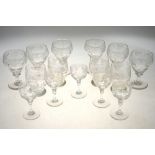 A set of six cut glass wine glasses etched with grape and vine,