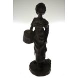 An Italian brown patinated bronze figure of a 19th century female carrying a band-box,