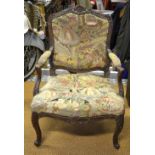 An 18th/19th century carved walnut framed fauteuille with tapestry back and serpentine seat