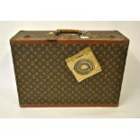 An early 20th century Louis Vuitton monogrammed suitcase with registration label no.902027, Ave