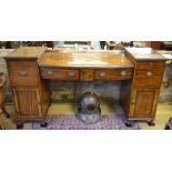 A mid 19th century ebony banded mahogany twin pedestal bow front sideboard having an arrangement of