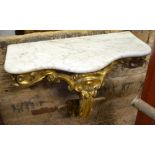 A Victorian carved giltwood hanging serpentine form console with original veined white marble top,