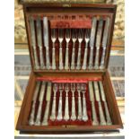 A set of twelve each silver dessert knives and forks with vine-embossed loaded handles, Samson &