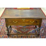 An 18th century joined oak side table, the wide three plank top with moulded edge over a single deep