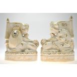 A pair of 1951 Festival of Britain Staffordshire pottery flatbacks, modelled with Royal lion and