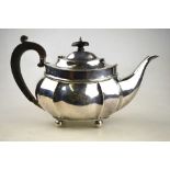 An oval silver teapot with beaded rim and ogee body, on ball feet, Thomas Edward Atkins,