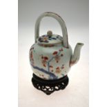 A Chinese Imari porcelain teapot and cover decorated with flowers and foliage, 15 cm, early 18th