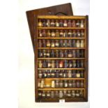 A travelling drug-box with eighty small bottles enclosed by sliding cover Condition Report