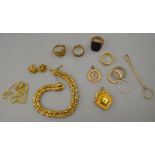 A collection of gold items including Georgian style two row linked bracelet, diamond set locket,
