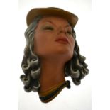 A 1940s John Douglas painted earthenware wall mask portrait of actress Vicky Lester.  33cm high