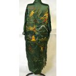 A 1950s Chinese green satin robe with gold metalissed embroidered dragon and an ivory silk panel