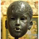 A brown patinated bronze head, portrait of a young child, unsigned, 18 cm high,