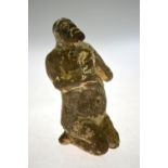 An antiquity (probably) North African terracotta figure of a kneeling baboon, holding an object, 11.