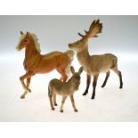 A Beswick Palamino pony, fallow deer, two small bay horses and a donkey foal, to/w a Royal Doulton