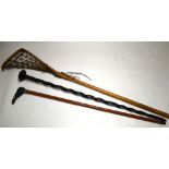 An ebony walking cane, the flattened pommel inlaid with ivory,