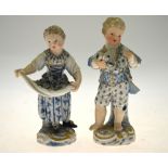 A pair of late 19th century Meissen figures of a boy and girl, he holding a garland of flowers and