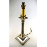 An Edwardian classical column candlestick wired as a table lamp,