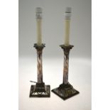 A pair of Old Sheffield plate Adam-style candlesticks, engraved with foliate swags,