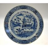 A Chinese blue and white porcelain plate decorated with a building in a watery landscape, early 19th