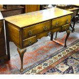 An 18th century oak side table having four frieze drawers within a fret cut apron,