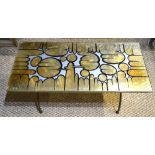 A retro vintage gold leaf and mixed media rectangular top coffee table, raised on a hoop cross-