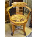 An antique oak swivel armchair,