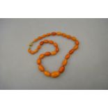 A graduated pressed amber bead necklace to/w a Mexican white metal and malachite necklace stamped