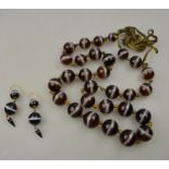 A row of graduated large banded agate beads with banded agate snap to/w pair of banded agate triple