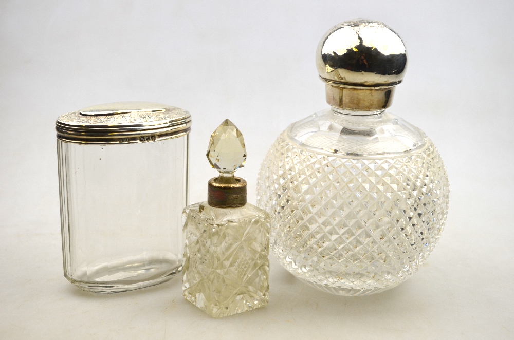 A Victorian hobnail-cut glass spherical scent bottle with silver bun screw-top, London 1884, to/w