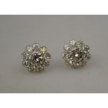 A pair of large diamond set flower cluster earrings having centre stones of approx 2 carats each