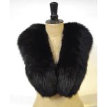 A brown French squirrel fur stole, a russet mink fur hat, an ivory mink hat, a black fox fur