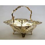 A late Victorian silver sweetmeat basket with loop handle, embossed,